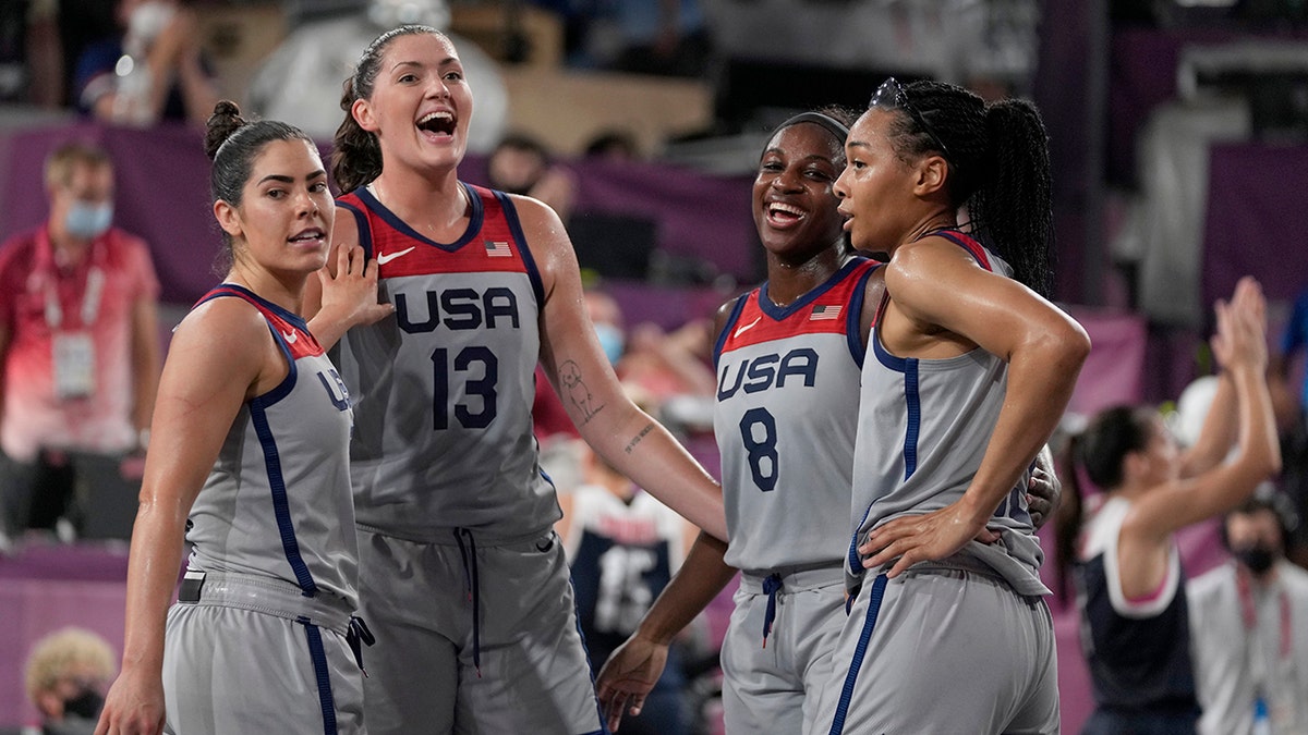 U.S. players Kelsey Plum, left, Stefanie Dolson (13), Jacquelyn Young (8) and Allisha Gray celebrate after defeating Russian Olympic Committee in a women's 3-on-3 gold medal basketball game at the 2020 Summer Olympic