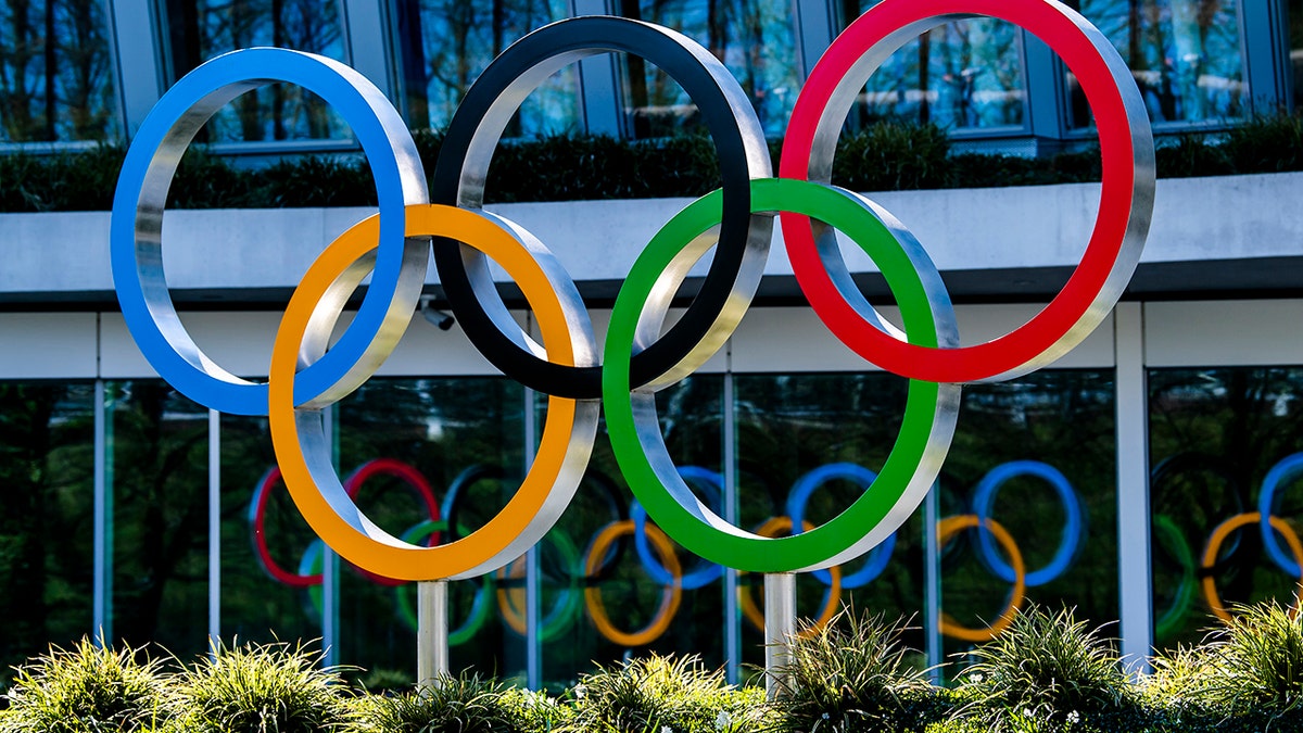 The Olympic Rings are displayed at the entrance of the IOC, International Olympic Committee headquarters during the coronavirus disease (COVID-19) outbreak in Lausanne, Switzerland, Tuesday, March 24, 2020. (Jean-Christophe Bott/Keystone via AP)