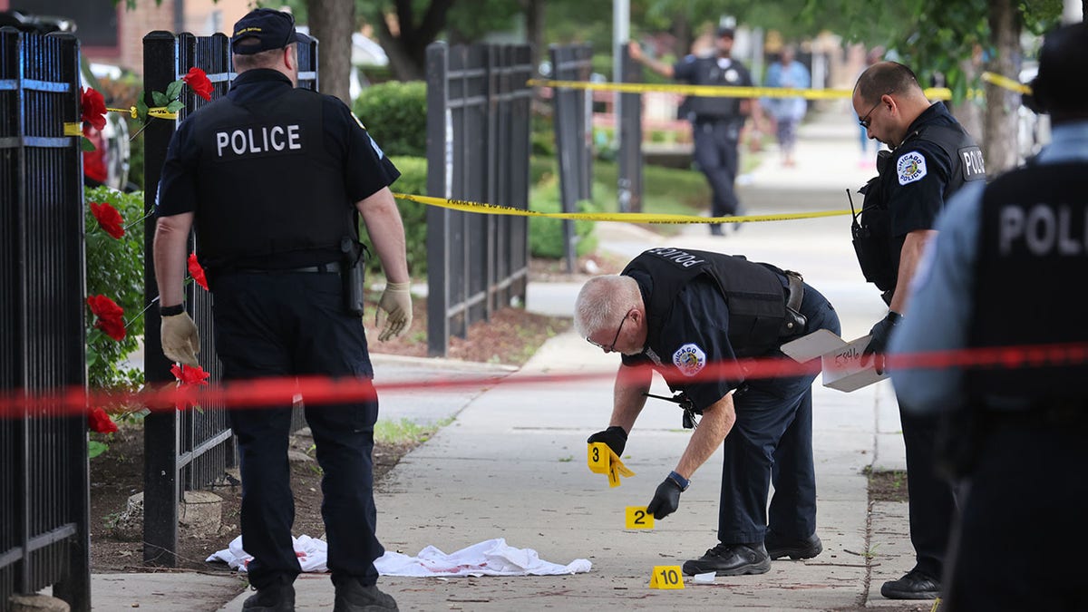 Police investigate a crime scene where three people were shot at the Wentworth Gardens housing complex in the Bridgeport neighborhood on June 23, 2021 in Chicago, Illinois. (Photo by Scott Olson/Getty Images)