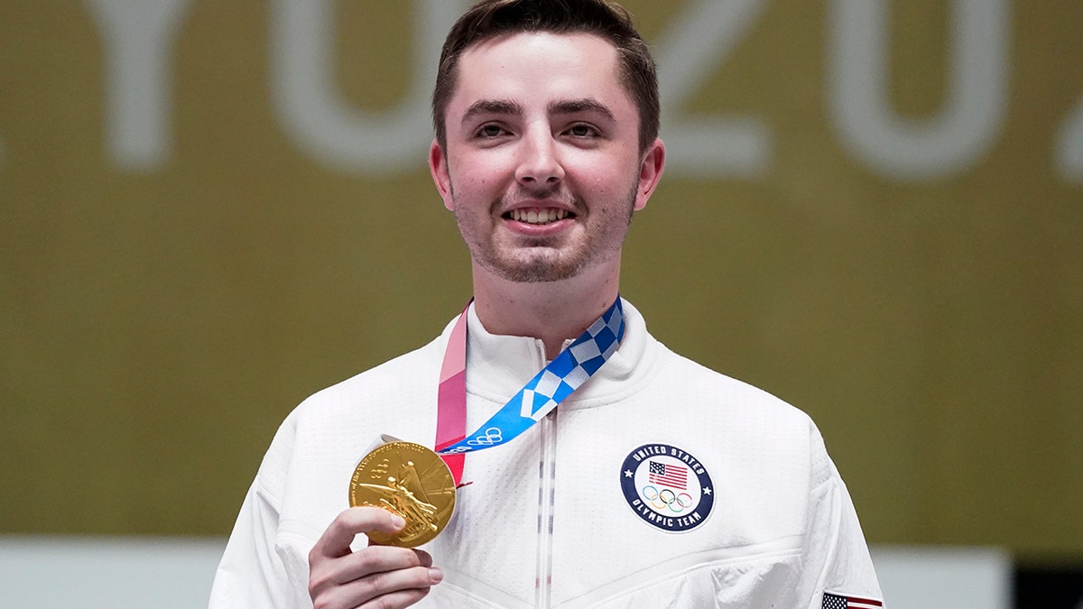 William Shaner, of the United States, holds his gold medal on after the men's 10-meter air rifle at the Asaka Shooting Range in the 2020 Summer Olympics