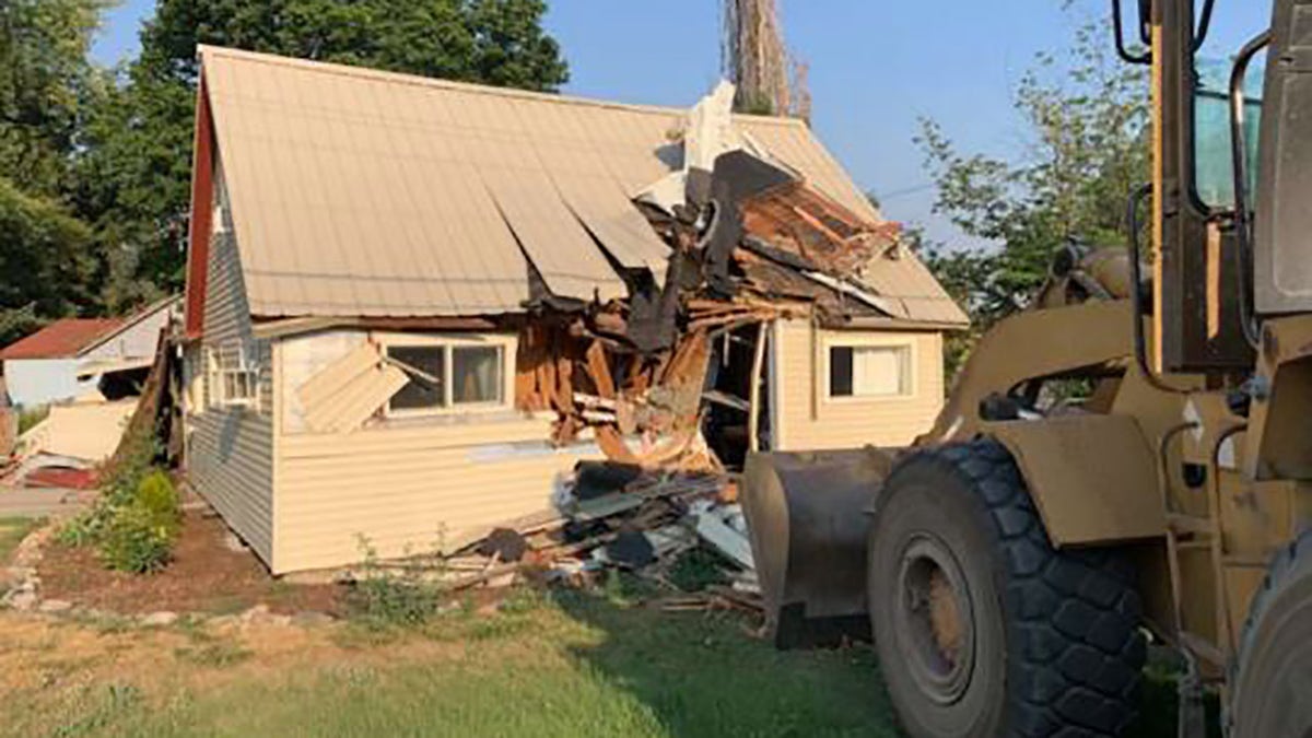 A Washington state man wearing a yellow dress was arrested after he stole a school bus and later drove a front-end loader construction vehicle through his and his estranged wife’s home, authorities said.