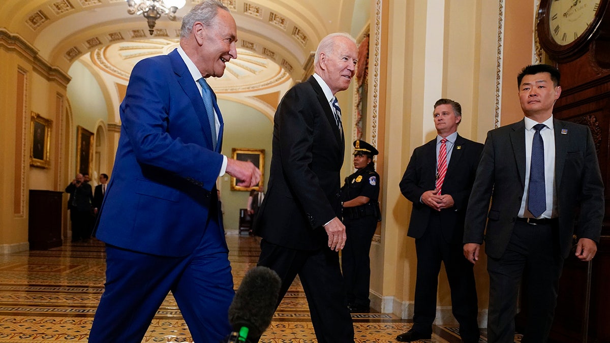 President Biden walks with Senate Majority Leader Chuck Schumer, D-N.Y., at the Capitol in Washington, Wednesday, July 14, 2021, as he arrives to discuss the latest progress on his infrastructure agenda. 
