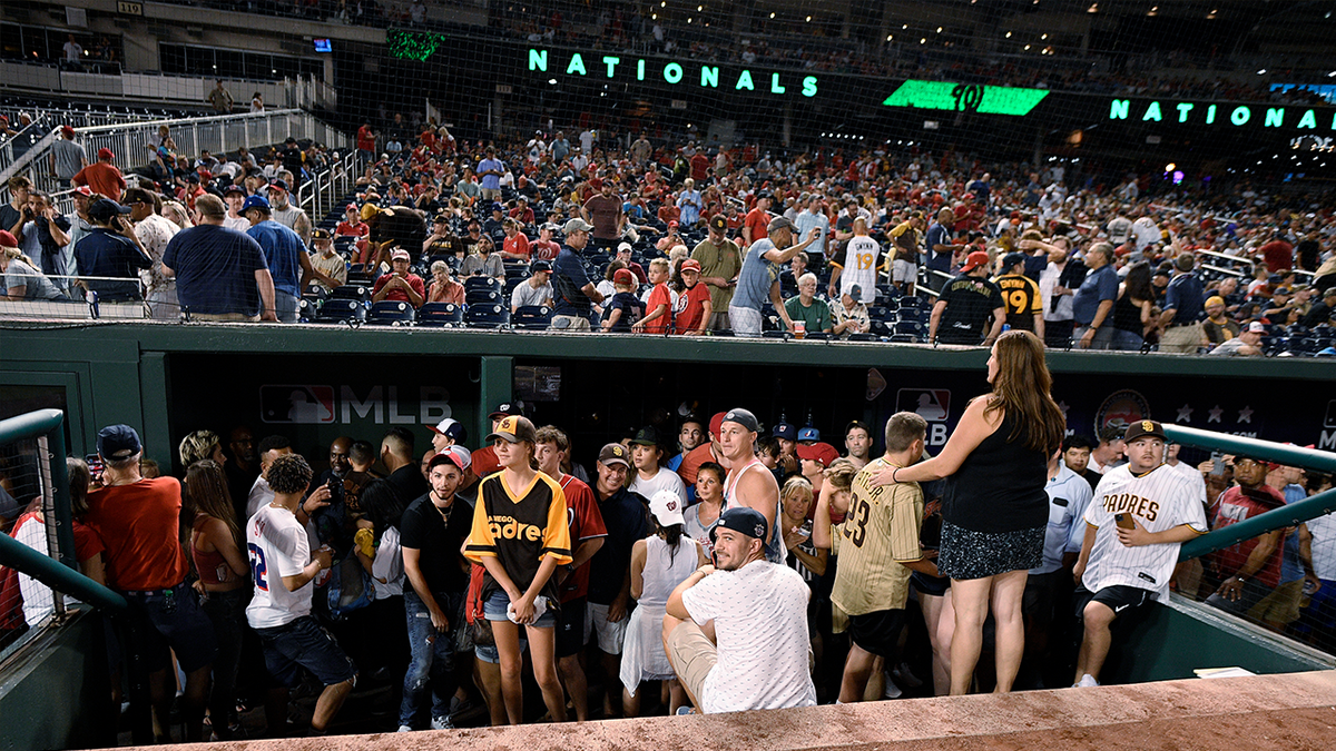 Fans are seen at Nationals Park after Saturday's game was delayed after the sound of gunfire. (Associated Press)