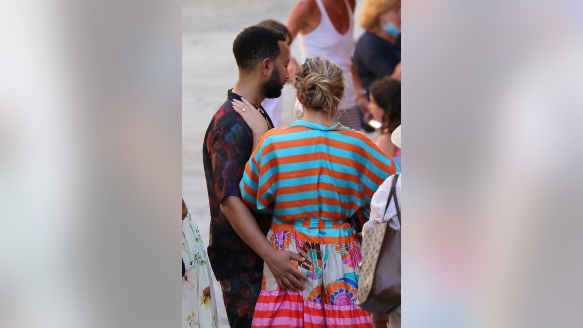 John Legend sweetly gives wife Chrissy Teigen a butt squeeze as the couple step out during their Italian getaway on July 6. 