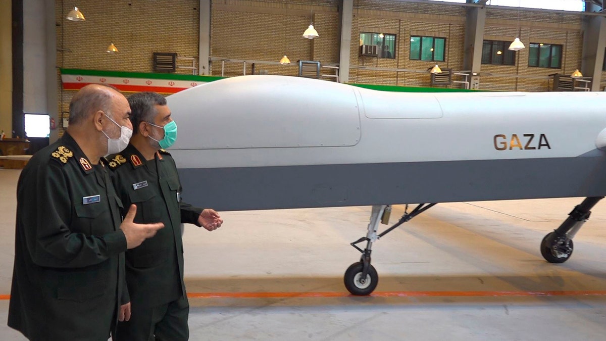 In this photo released on Saturday, May 22, 2021, by Sepahnews of the Iranian Revolutionary Guard, the Guard's Commander Gen. Hossein Salami, left, and the Guard's aerospace division commander Gen. Amir Ali Hajizadeh talk while unveiling a new drone called "Gaza" in an undisclosed location in Iran. 