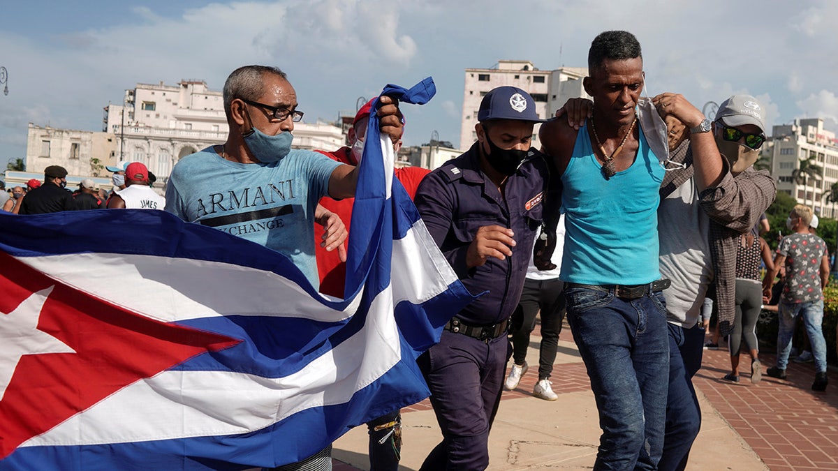 Police detain a person during protests against and in support of the government, amidst the coronavirus disease (COVID-19) outbreak, in Havana, Cuba July 11, 2021. 