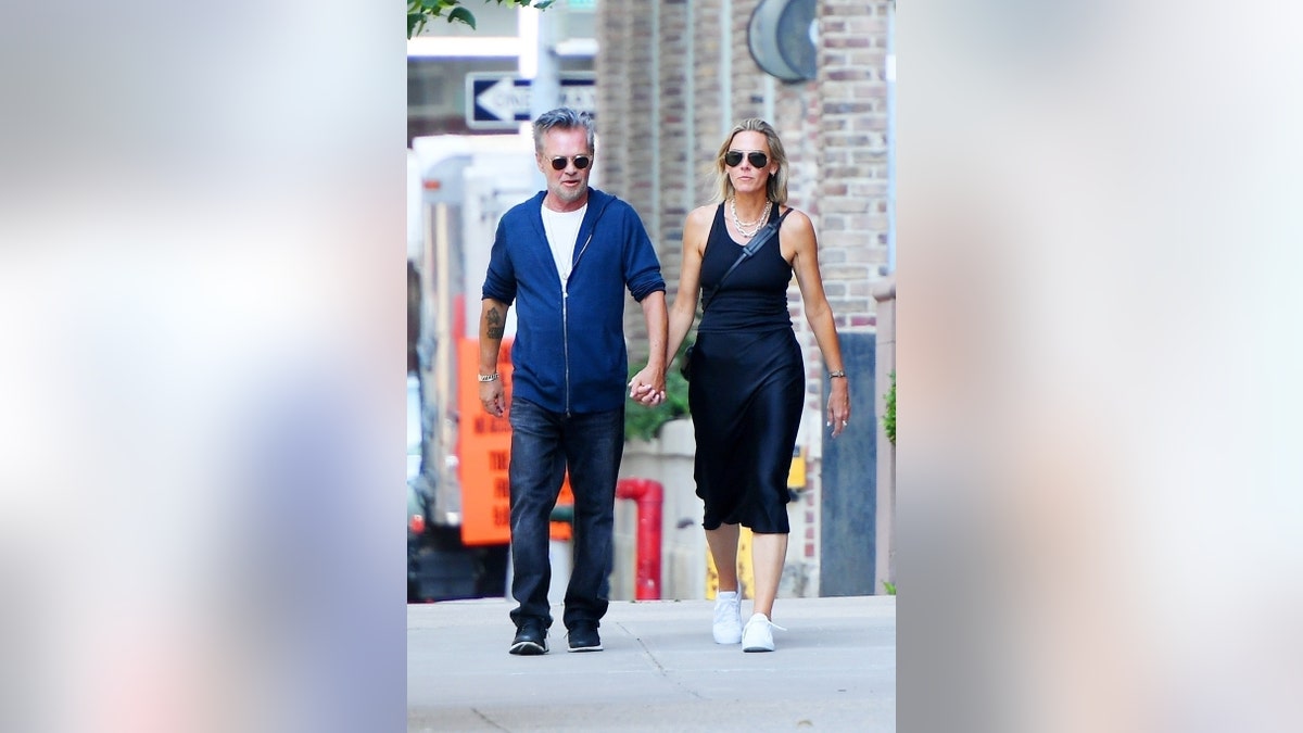 Mellencamp holds hands with his new real estate girlfriend Natasha Barrett in Tribeca.