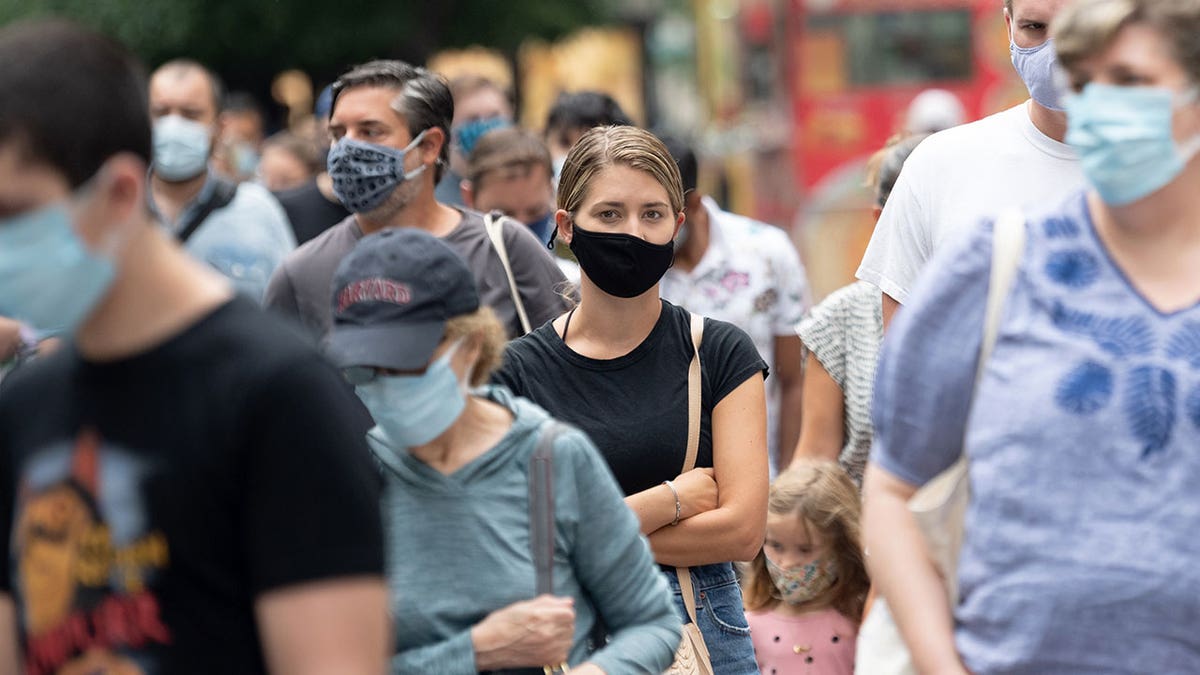 person wearing a mask in new york crowd