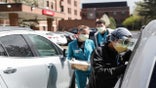 FILE - In this April 15, 2021, file photo, Emergency Room technicians test patients for Covid-19 outside of the emergency entrance of Beaumont Hospital in Grosse Pointe, Mich. Michigan has become the current national hotspot for COVID-19 infections and hospitalizations at a time when more than half the U.S. adult population has been vaccinated and other states have seen the virus diminish substantially. Beaumont Health warned that its hospitals and staff had hit critical capacity levels.