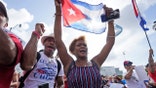 Dulce Diaz, center, and her brother Carlos Diaz, left, demonstrate, Wednesday, July 14, 2021, in Miami's Little Havana neighborhood, as people rallied in support of antigovernment demonstrations in Cuba. (AP Photo/Wilfredo Lee)