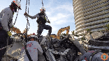 Search and recovery crews in Surfside, Fla., continue to move the rubble of the former Champlain Towers South building.