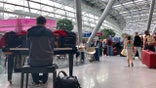 13 July 2019, North Rhine-Westphalia, Duesseldorf: A musician commissioned by the airport plays the piano at the airport to entertain travellers. Summer holidays have begun in North Rhine-Westphalia. Photo: Oliver Auster/dpa (Photo by Oliver Auster/picture alliance via Getty Images)