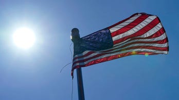 Video of child ripping flag from yard and tossing it as adult looks on goes viral