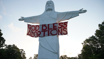 'GOD BLESS ABORTIONS' banner hung on Christ of the Ozarks statue in Arkansas by activist art group