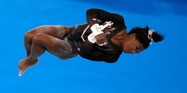 Simone Biles, of United States, trains on the uneven bars for the artistic gymnastics at Ariake Gymnastics Centre venue ahead of the 2020 Summer Olympics, Thursday, July 22, 2021, in Tokyo, Japan. (AP Photo/Natacha Pisarenko)