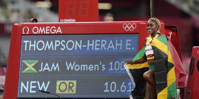 Elaine Thompson-Herah, of Jamaica, celebrates after winning the women's 100-meter final at the 2020 Summer Olympics, Saturday, July 31, 2021, in Tokyo. (AP Photo/Martin Meissner)