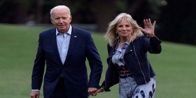 President Joe Biden and first lady Jill Biden walk on the South Lawn of the White House after stepping off Marine One on Sunday in Washington. (AP)