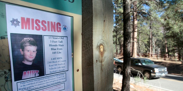 In this Nov. 26, 2012, file photo, a missing poster of 13-year-old Dylan Redwine hangs on a trail head sign next to Vallecito Reservoir in Vallecito, Colo. 