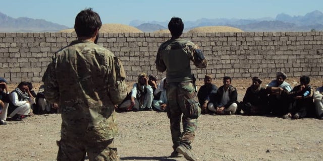 Moneer and Greg Adams speaking to village elders and recruits from throughout the Afghan district.