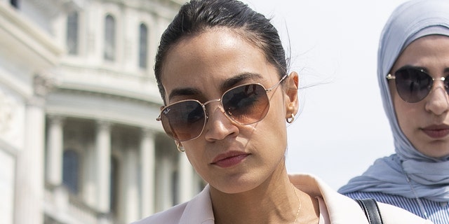UNITED STATES - JULY 1: Rep. Alexandria Ocasio-Cortez, D-N.Y., talks with a reporter as she walks down the House steps after the last votes of the week in Washington on Thursday, July 1, 2021. (Photo by Caroline Brehman/CQ-Roll Call, Inc via Getty Images)