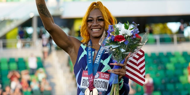Sha'Carri Richardson waves after winning the women's 100-meter run at the U.S. Olympic Track and Field Trials Saturday, June 19, 2021, in Eugene, Ore. (AP Photo/Ashley Landis)