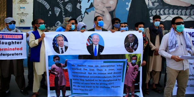 In this June 25, 2021 photo, Former Afghan interpreters hold placards during a demonstrations against the US government, in front of the US Embassy in Kabul, Afghanistan. 