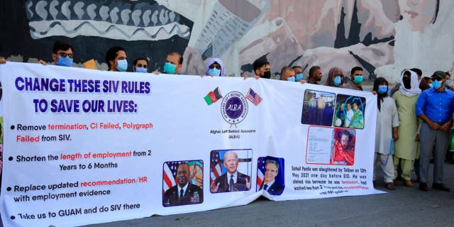 In this June 25, 2021 photo, former Afghan interpreters hold placards during a demonstrations against the US government, in front of the US Embassy in Kabul, Afghanistan. 