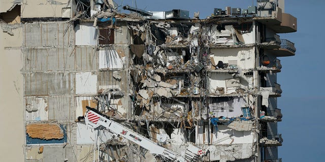 Heavy machinery sits parked outside the still standing section of the Champlain Towers South condo building, July 1, 2021, in Surfside, Florida. (Associated Press)
