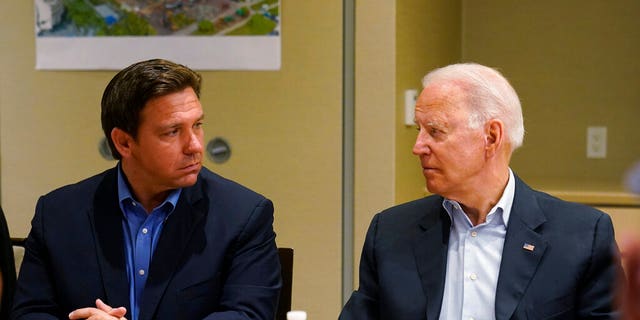 President Joe Biden, right, looks at Florida Gov. Ron DeSantis, left, during a briefing with first responders and local officials in Miami, Thursday, July 1, 2021, on the condo tower that collapsed in Surfside, Fla., last week. (AP Photo/Susan Walsh)