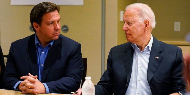 President Joe Biden, right, looks at Florida Gov. Ron DeSantis, left, during a briefing with first responders and local officials in Miami, Thursday, July 1, 2021, on the condo tower that collapsed in Surfside, Fla., last week. (AP Photo/Susan Walsh)