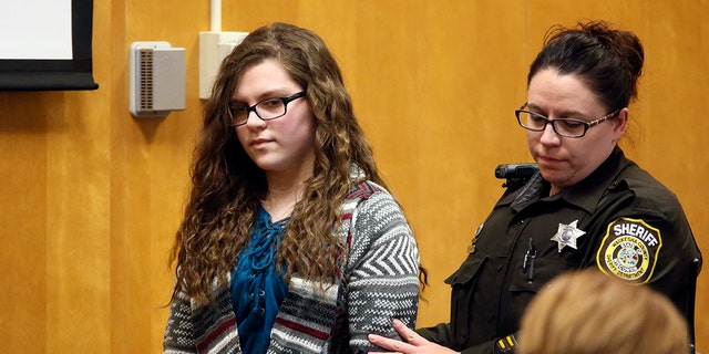 Anissa Weier, one of two Wisconsin girls who tried to kill a classmate to win favor with a fictional horror character named Slender Man, is led into court for her sentencing hearing in Waukesha, Wisconsin.