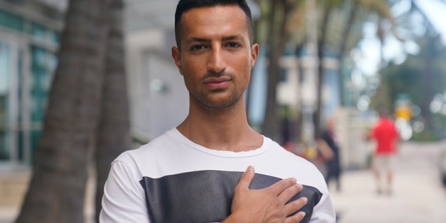 Gabriel Nir, who lived on the first floor of the Champlain Towers South condo building that collapsed, poses for a portrait outside the hotel where he is now staying in Surfside, Fla., on Friday, July 2, 2021. He had just finished a late night workout and was in the kitchen cooking salmon. The rest of the family would normally be asleep, but his 15-year-old sister had just returned from babysitting and was in the shower, his dad was out of town and his mom had just come home from an event. They all heard the first thunderous rumble. They knew the building was undergoing construction and had been irritated by the incessant noise, but this felt different. (AP Photo/Gerald Herbert)