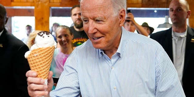 President Joe Biden holds an ice cream cone as he visits Moomers Homemade Ice Cream, Saturday, July 3, 2021, in Traverse City, Mich. (AP Photo/Alex Brandon)