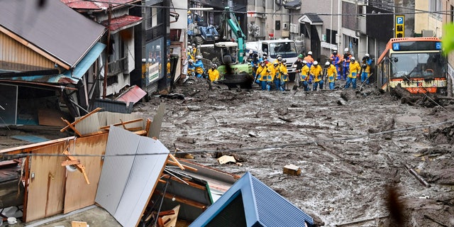 Rescuers conduct a search operation at the site of a mudslide at Izusan in Atami, Shizuoka prefecture, southwest of Tokyo, Sunday, July 4, 2021. More than 1,000 soldiers, firefighters and police on Sunday waded through a giant mudslide that ripped through the resort town as it swept away houses and cars. (Kyodo News via AP)