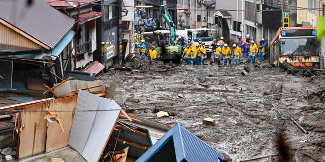 Rescuers conduct a search operation at the site of an Izusan mudslide in Atami, Shizuoka prefecture, southwest of Tokyo, Sunday, July 4, 2021. More than 1,000 soldiers, firefighters and police waded through Sunday in a giant mudslide that devastated the city seaside resort, sweeping away homes and cars. (Kyodo news via AP)