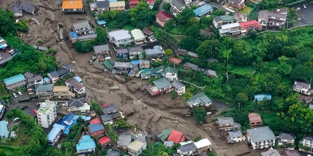 This aerial photo shows the site of a mudslide at Izusan in Atami, Shizuoka prefecture, southwest of Tokyo, Sunday, July 4, 2021. More than 1,000 soldiers, firefighters and police on Sunday waded through a giant mudslide that ripped through the resort town as it swept away houses and cars. (Kyodo News via AP)