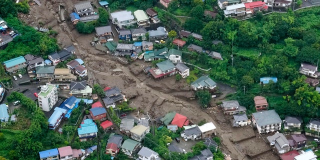 This aerial photo shows the site of an Izusan mudslide in Atami, Shizuoka Prefecture, southwest of Tokyo, on Sunday, July 4, 2021. More than 1,000 soldiers, firefighters and police waded through a mudslide on Sunday. giant mud that ravaged the seaside resort as it washed away houses and cars. (Kyodo news via AP)