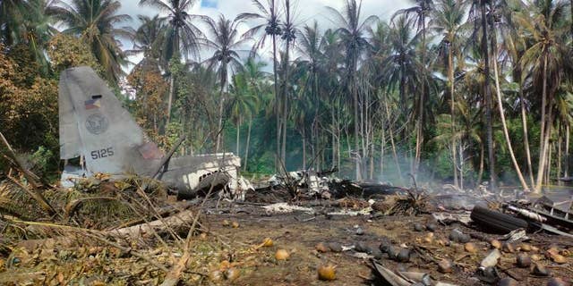 THIS CORRECTS THE NAME OF THE PROVINCE TO SULU, INSTEAD OF JOLO - This photo released by the Joint Task Force - Sulu shows the remains of a Philippine military C-130 plane that crashed in Patikul town, Sulu province, southern Philippines on Sunday, July 4, 2021. The Philippine air force C-130 aircraft carrying troops crashed in a southern province after missing the runway Sunday, killing more than a dozen military personnel while at least 40 were rescued from the burning wreckage, officials said. (Joint Task Force-Sulu via AP)