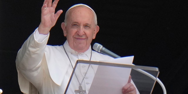 Pope Francis waves to the crowd as he arrives to recite the Angelus noon prayer from the window of his studio overlooking St. Peter's Square, at the Vatican on July 4, 2021. (Associated Press)