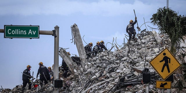 Rescuers search for victims at a collapsed South Florida condo building Monday, July 5, 2021, in Surfside, Fla., after demolition crews set off a string of explosives that brought down the last of the Champlain Towers South building in a plume of dust on Sunday. 