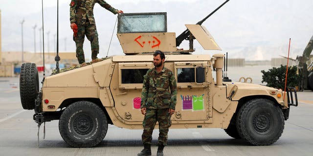 Afghan army soldiers stand guard after the American military left Bagram air base, in Parwan province north of Kabul, Afghanistan, Monday, July 5, 2021.