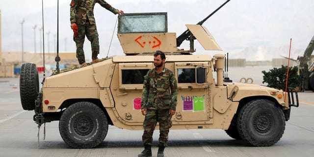 Afghan army soldiers stand guard after the American military left Bagram air base, in Parwan province north of Kabul, Afghanistan, Monday, July 5, 2021. 