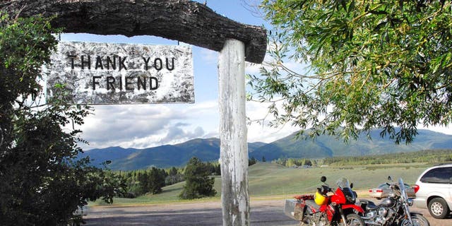 In this July 9, 2009, file photo, the Bob Marshall Wilderness cuts a jagged line across the horizon as patrons leave Trixi's Antler Saloon in Ovando, Mont.