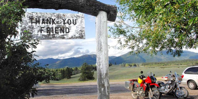 In this July 9, 2009, file photo, the Bob Marshall Wilderness cuts a jagged line across the horizon as patrons leave Trixi's Antler Saloon in Ovando, Mont.