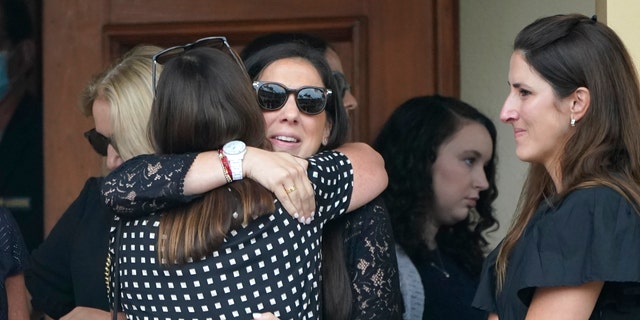 Family and friends arrive for a funeral service for Marcus Guara and his family at St. Joseph Catholic Church, Tuesday, July 6, 2021, in Miami Beach, Fla. Guara, his wife Anaely, and daughters Lucia and Emma, died in the collapse of the Champlain Towers South condominium building in nearby Surfside. (AP Photo/Lynne Sladky)