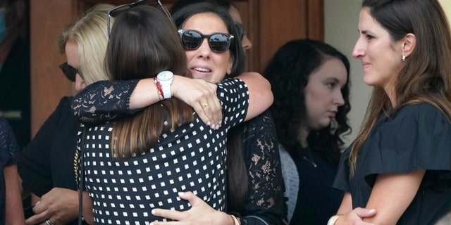 Family and friends arrive for a funeral service for Marcus Guara and his family at St. Joseph Catholic Church, Tuesday, July 6, 2021, in Miami Beach, Fla. Guara, his wife Anaely, and daughters Lucia and Emma, died in the collapse of the Champlain Towers South condominium building in nearby Surfside. (AP Photo/Lynne Sladky)