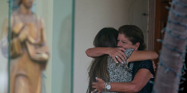 Family and friends arrive for the funeral service for Marcus Guara, 52, his wife Anaely Guara, 42, and their girls, 10-year-old Lucia and 4-year-old Emma at St. Joseph Catholic Church, Tuesday, July 6, 2021, in Miami Beach, Fla. Guara, his wife Anaely, and daughters Lucia and Emma, died in the collapse of the Champlain Towers South condominium building in nearby Surfside. (Matias J. Ocner /Miami Herald via AP)