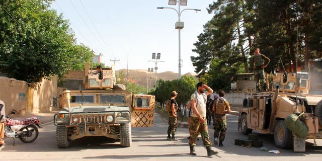 Afghan soldiers pause on a road at the front line of fighting between Taliban and Security forces, in Badghis province, northwest of Afghanistan, Wednesday, July, 7 2021. 