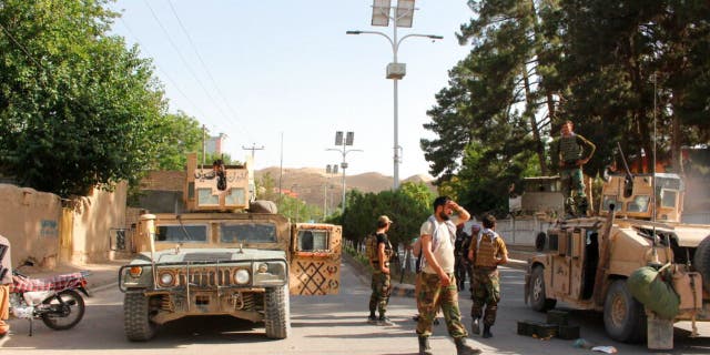 Afghan soldiers pause on a road at the front line of fighting between Taliban and Security forces, in Badghis province, northwest of Afghanistan, Wednesday, July, 7 2021.