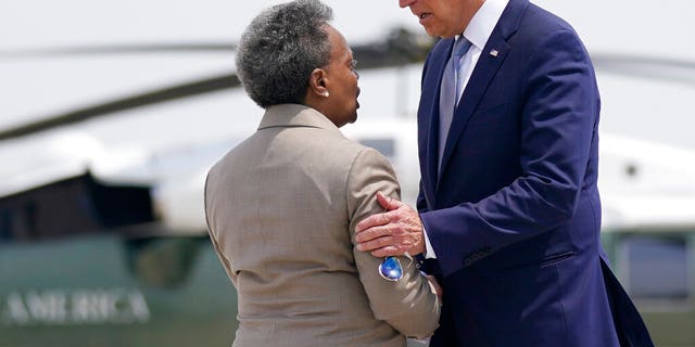 President Joe Biden greets Chicago Mayor Lori Lightfoot as he arrives at O'Hare International Airport in Chicago on Wednesday, July 7, 2021.  (AP Photo / Evan Vucci)